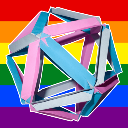 Photo of a geometric shape made of origami folded paper in pink, blue, and grey. The origami creates a framework of a dodecahedron (12 sided polygon) and it's layered over a striped background of rainbow colors.